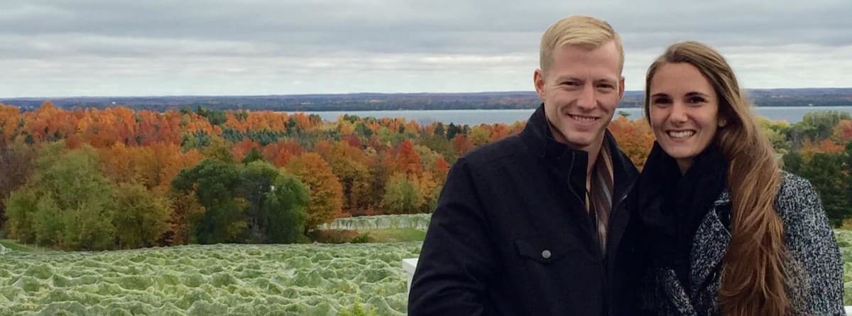Alex Host above a lake in northern Michigan, fall colors behind